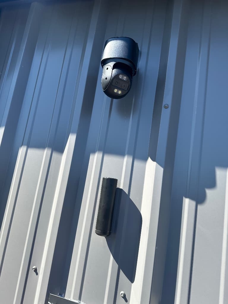Exterior PTZ surveillance camera mounted on a commercial building
