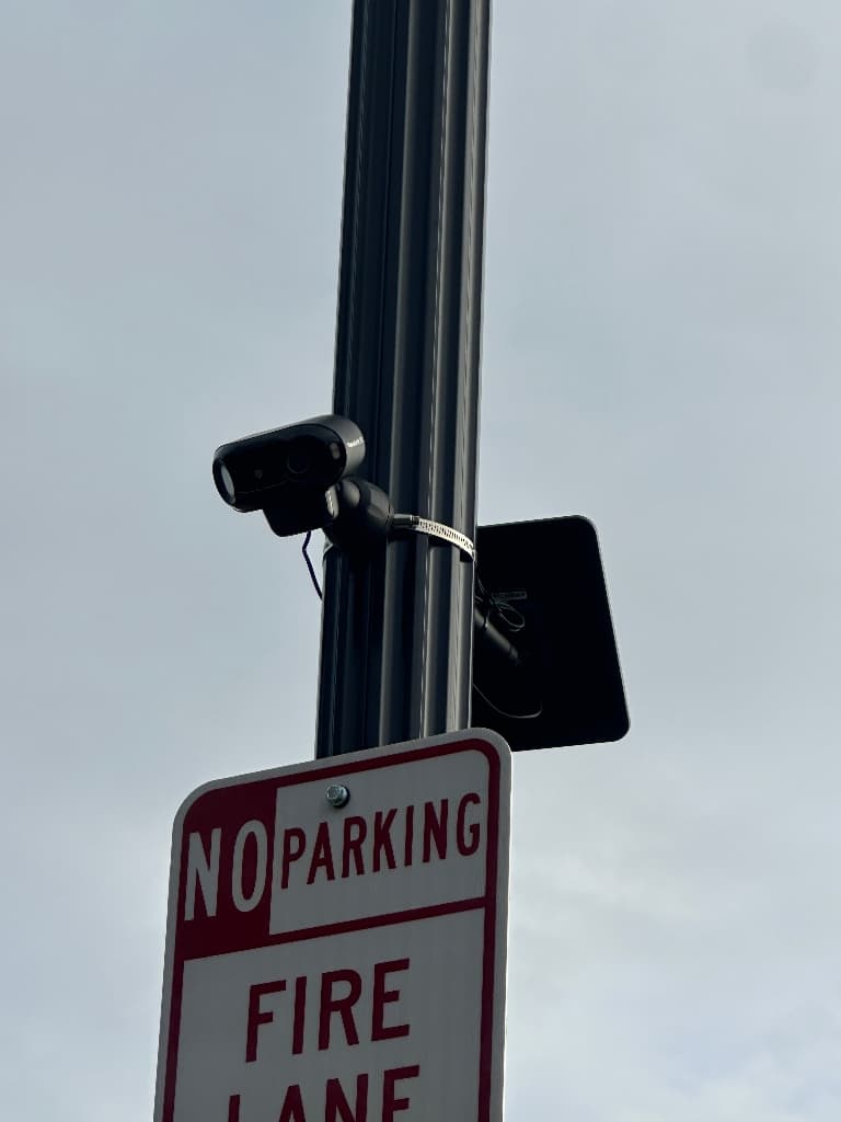 Pole-mounted surveillance camera deployed outdoors