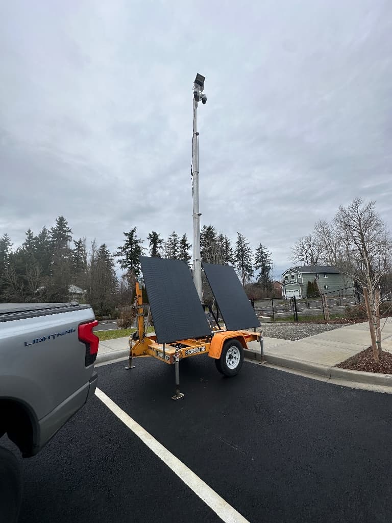 Mobile surveillance trailer deployed in a paved commercial area